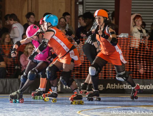 Pink Pistols MVP Una BOMBHer makes a move to get around Camaro Harem blockers RallyKat and Madam Mayhem. Photo by Jason Garland.